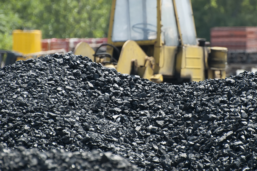 Excavator and coal piles